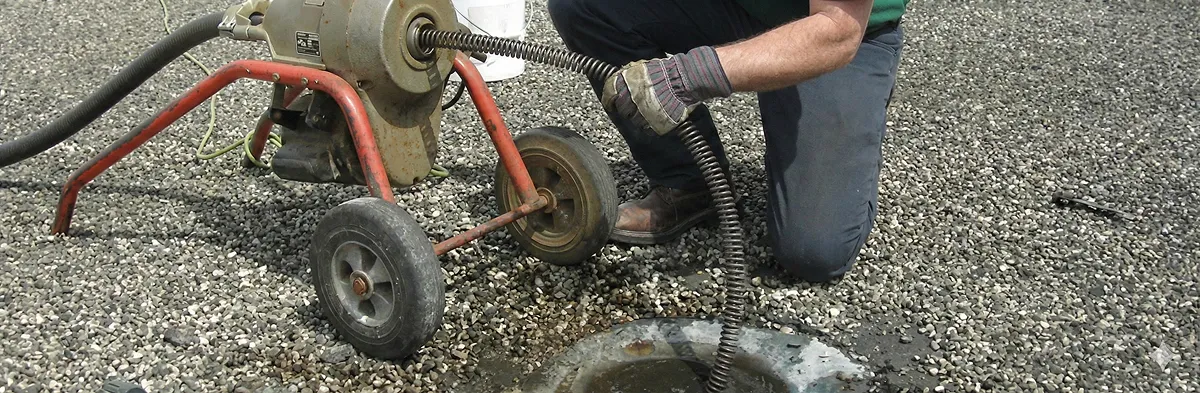 sewer rodding technician actively removing blockages from a sewer line in Staten Island, NY